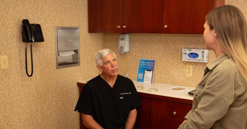 Dr. Parker talking to a patient in his office.